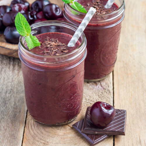 Black forest smoothie with cherry, almond milk and cacao powder in glass jar, horizontal, copy space