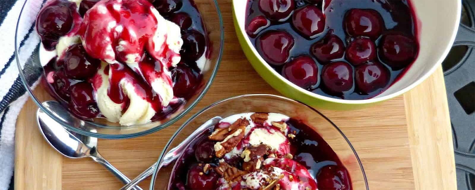 Cherry sauce over vanilla ice cream